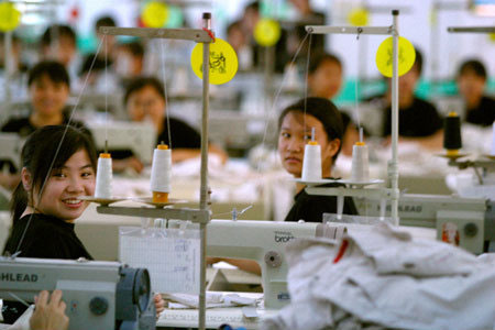 Chinese textile factory workers pause to chat