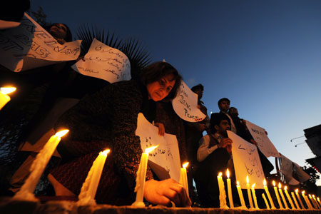 Pakistani human rights activists light candles - to pay tribute to Pakistani soldiers killed in a NATO strike