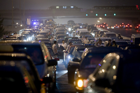 Beijing traffic jam - Long queues of cars grind to a halt as drivers talk to each other perplexed