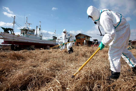 Fukushima radioactive leaks one year on - Japanese police officers search for missing persons in Ukedo