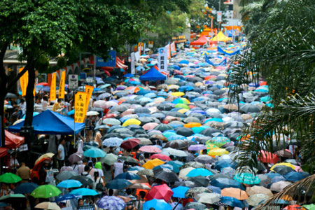 Hong Kong protestors brave the rains in a sea of umbrellas as they march for democracy, July 2014