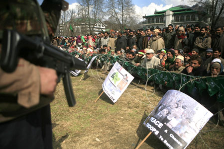 Kashmir flashpoint - Indian policeman stands guard at a PDP rally in Srinagar